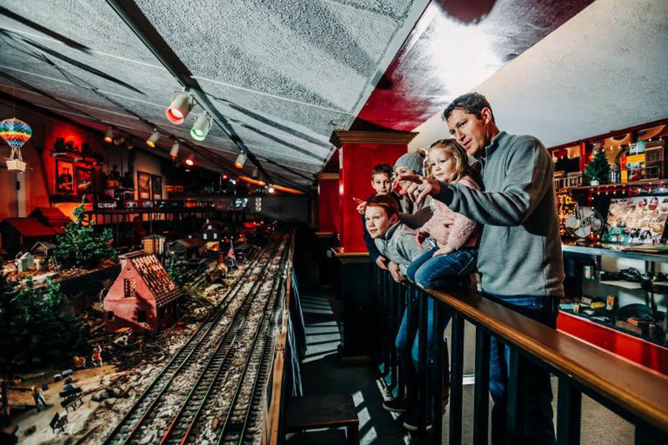 family looking at miniature train display