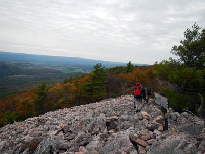 a person trekking boulder trail