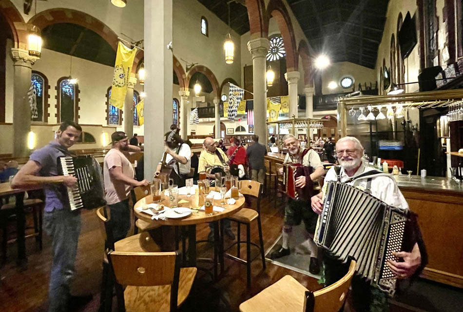 musicians playing near table inside brewery 