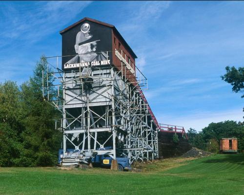 A large metal tower with graffiti on top