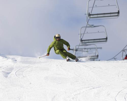 person skiing down hill