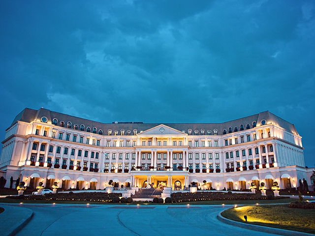 A night-time photo of the chateau at Nemacolin Woodlands Resort in Farmington, PA. 