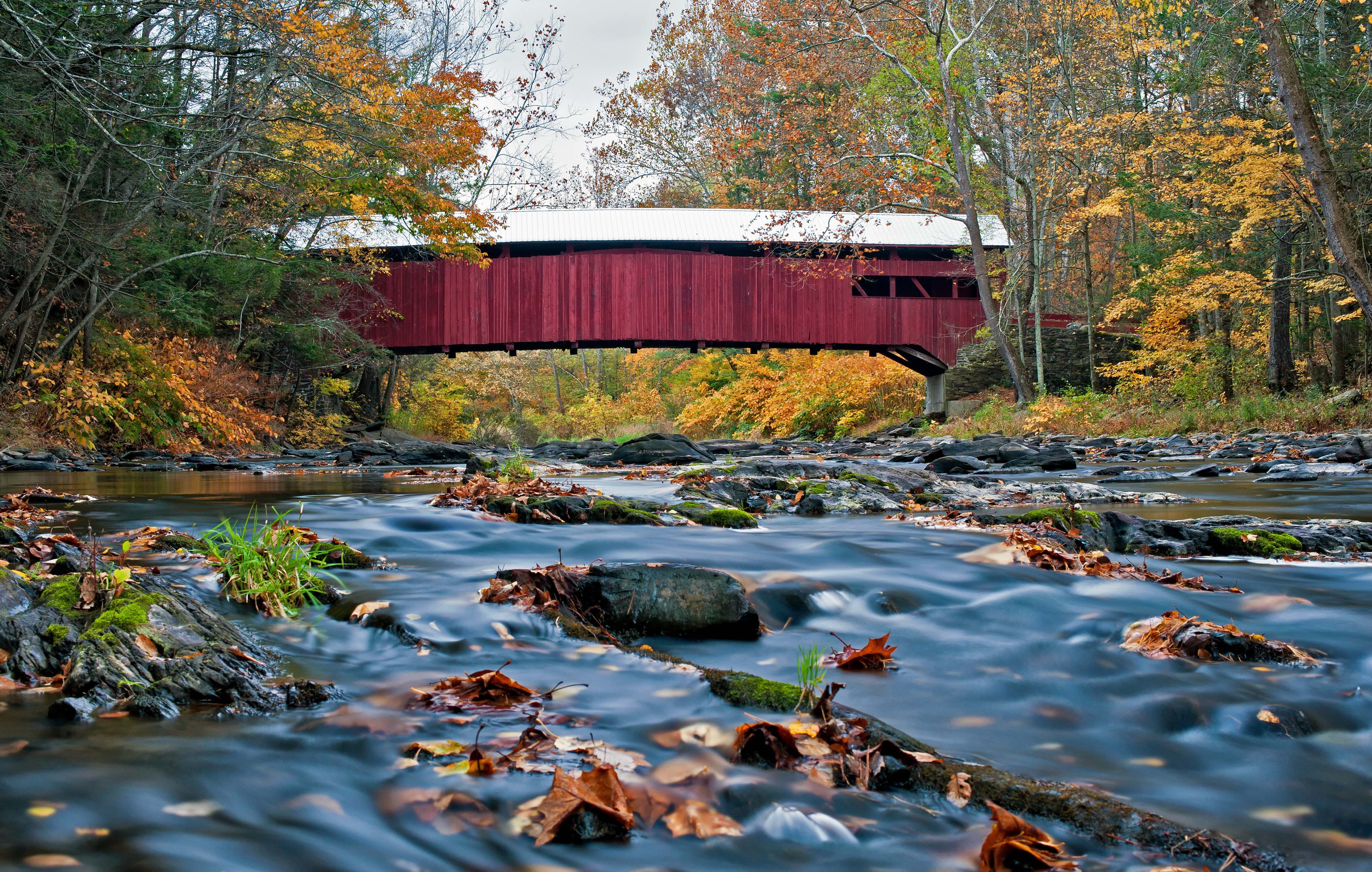 covered bridge with picturesque river underneath