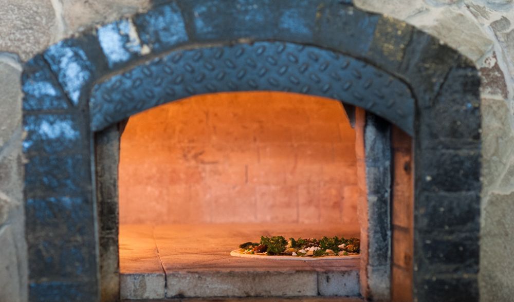 Stone pizza oven with pizza cooking inside