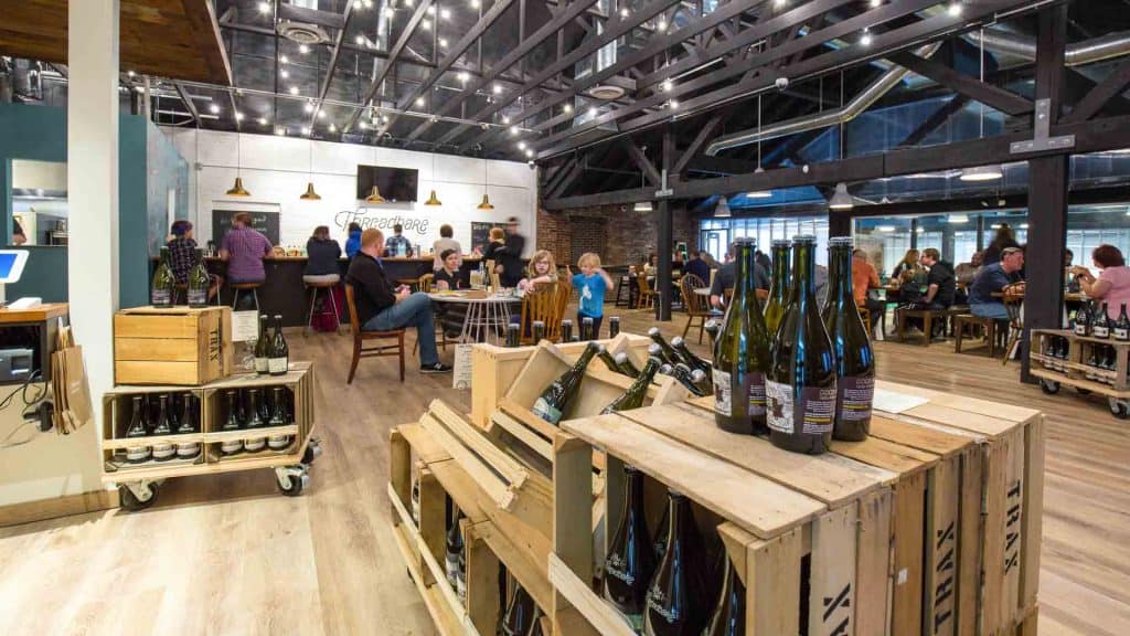 Inside the tasting room with wooden crates holding glass bottles of cider