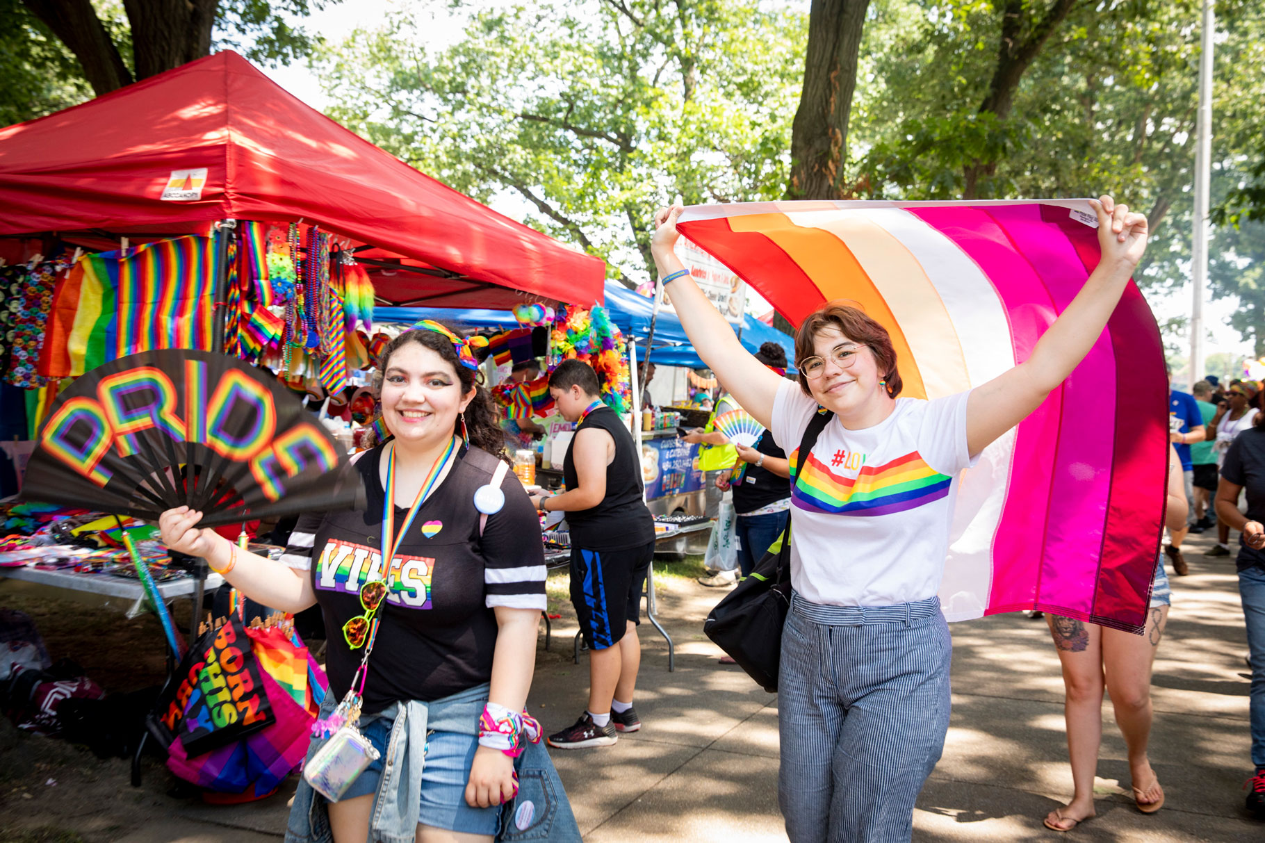 people holding pride flag in pride festival