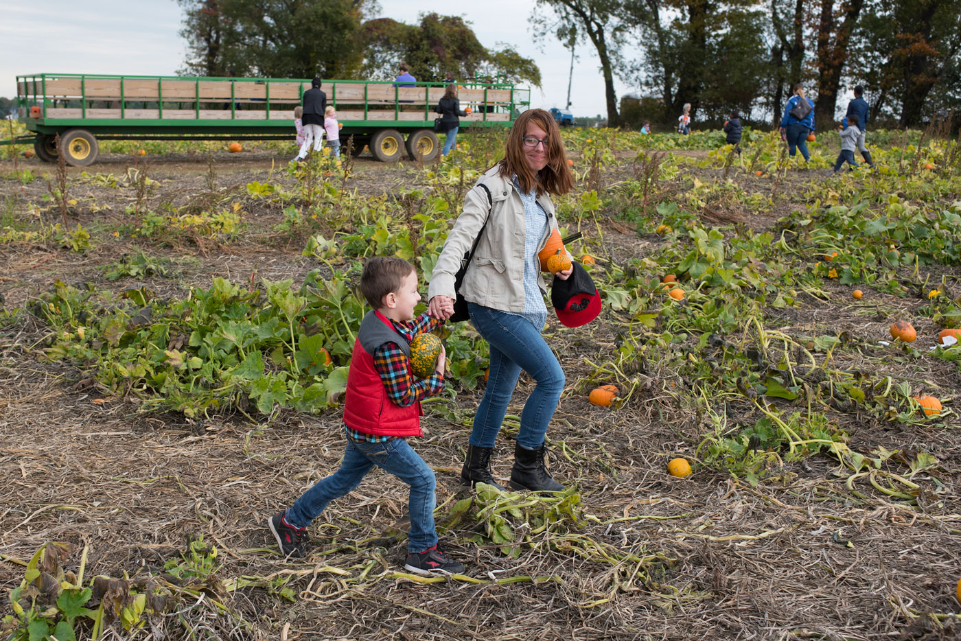 Mother and son picking pumpkins