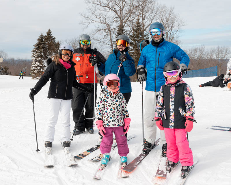 Family posing for a photo with Ski Gear