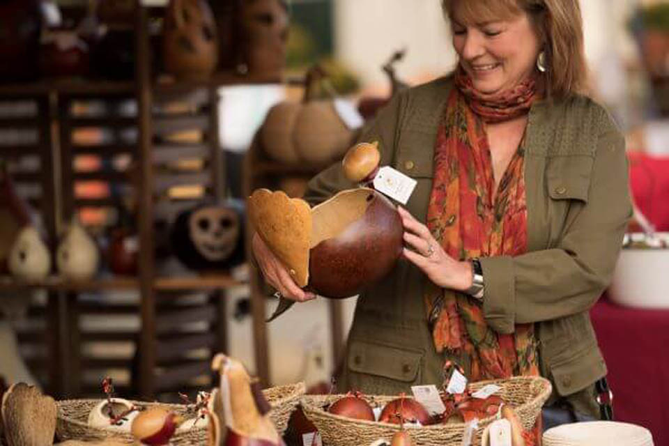 a women looking at craft piece