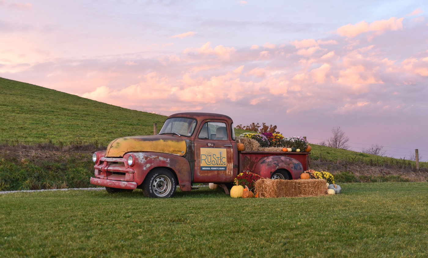 Old Truck in the farm loaded with hay and pumpkins