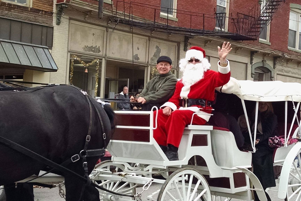 Santa riding horse carriage