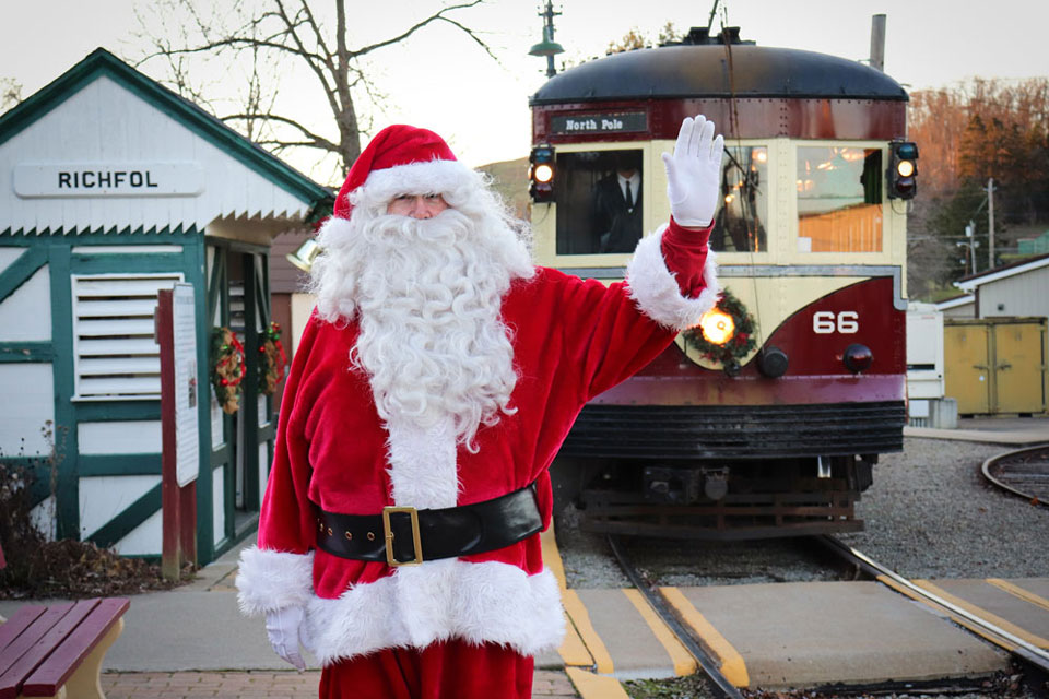 Santa Waving in front of Train Trolley