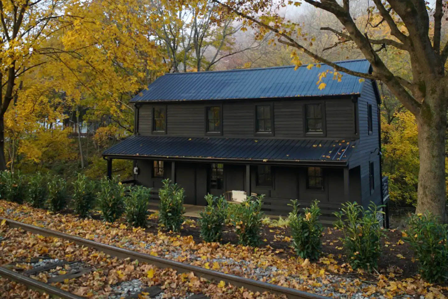 Creek house a restored historic cottage by train track
