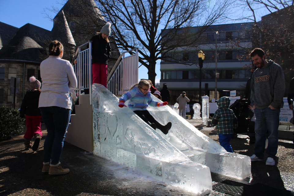 people sliding down ice slide