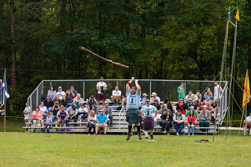 people sitting on stands watching highland games