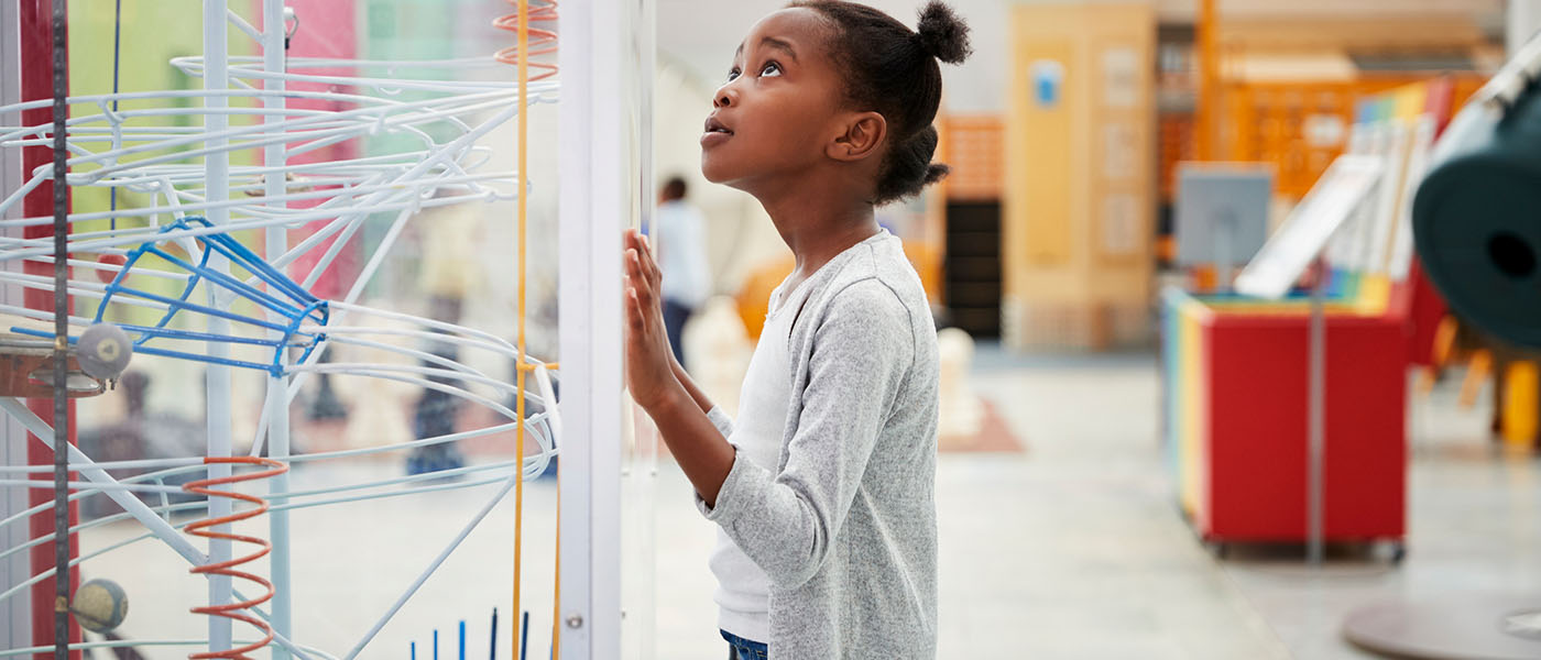 little girl looking at art collection