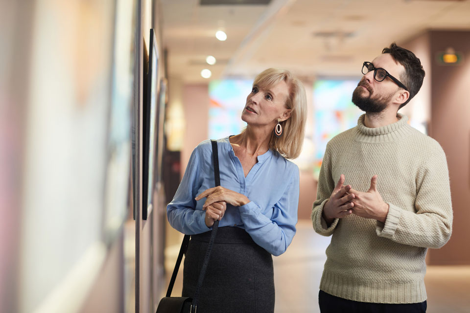 Two people looking at artwork