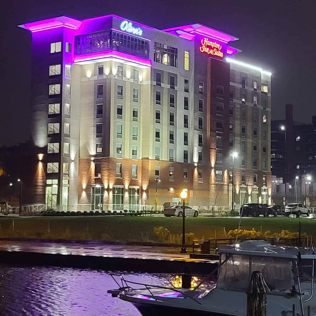 hotel building at night by lakefront