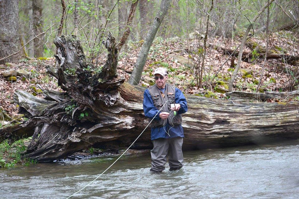 a person standing in the river fishing