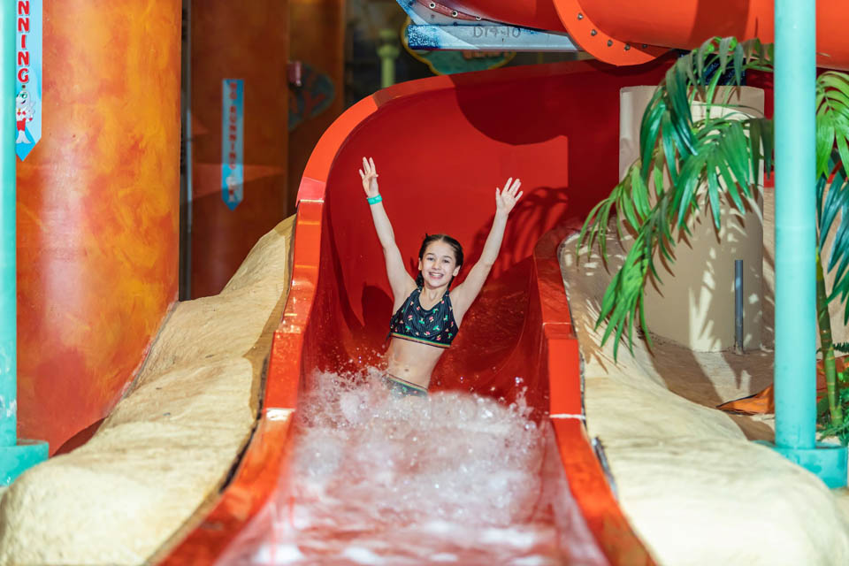 a girl sliding down a water slider