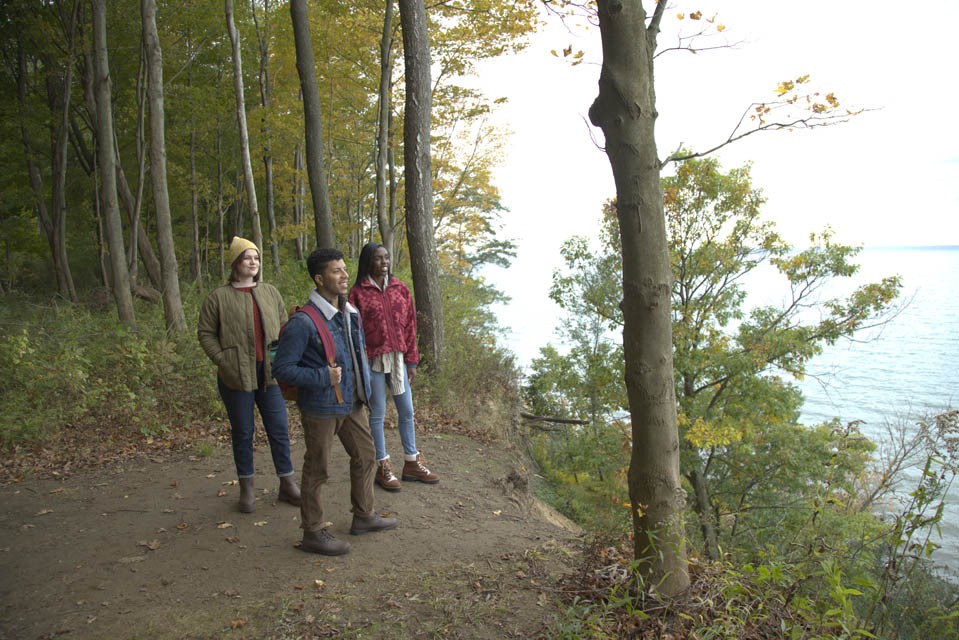 Three hiking enthusiasts looking at the lake from view point