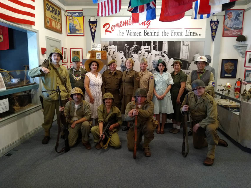 A group of people dressed in wwii uniforms for reenactments