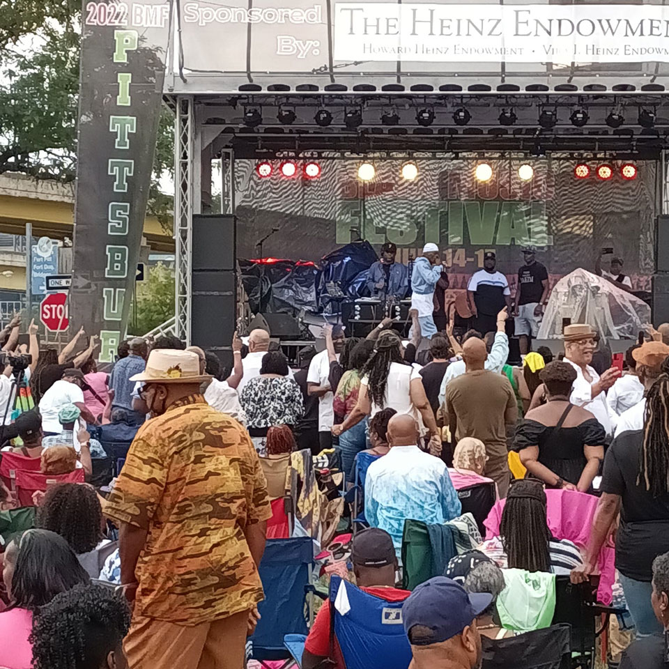 people watching artist performing on stage