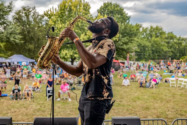 artist playing saxophone