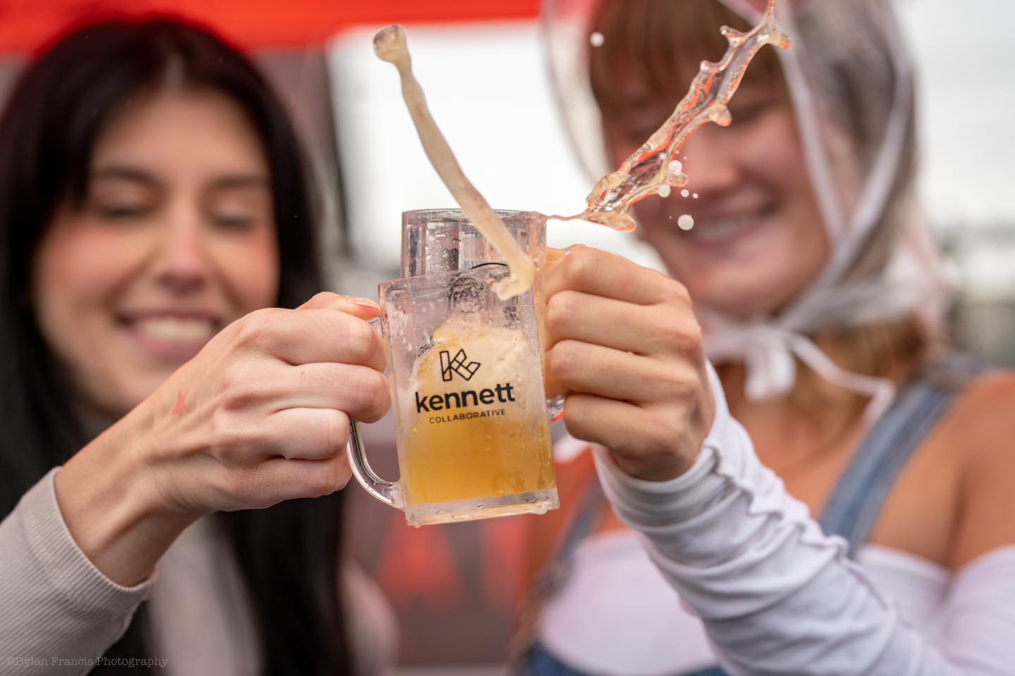 two persons holding glasses of beer