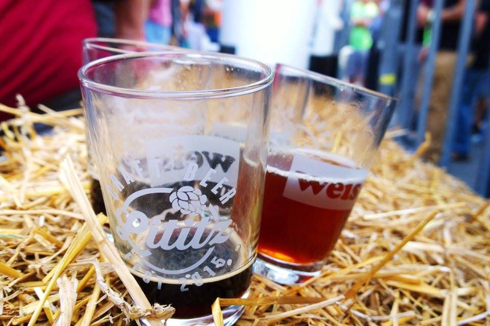 Beer pour glasses placed on Hay stack
