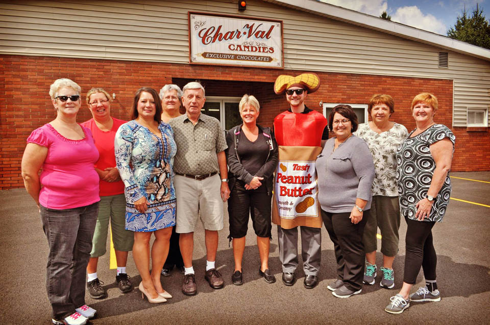 group of people posing with a person dress as peanut butter