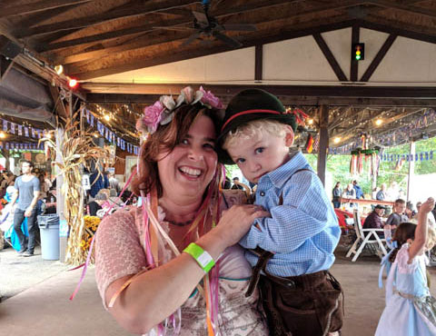 A woman holding at kid