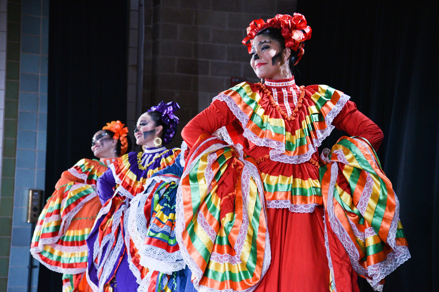 three women performing on stage