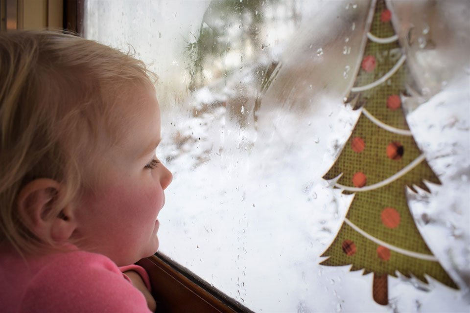 kid viewing thru train car window