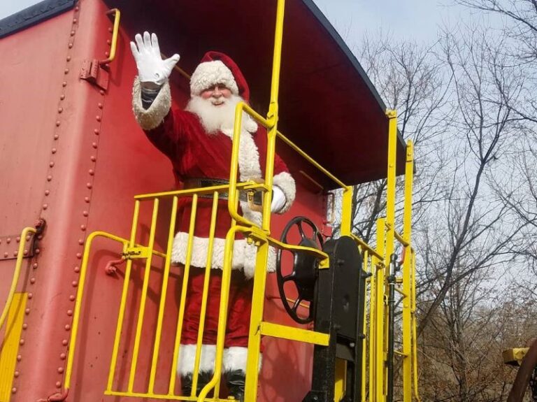 Santa waving standing on last train car