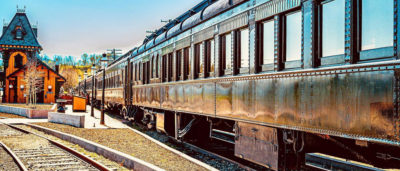 train wagon with cars parked at train station