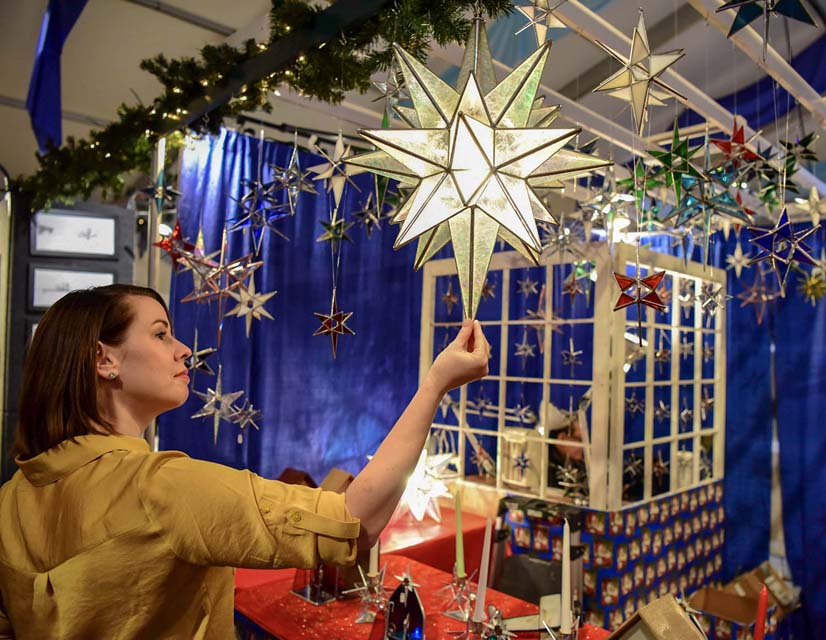 A woman looking at a Christmas Star Light
