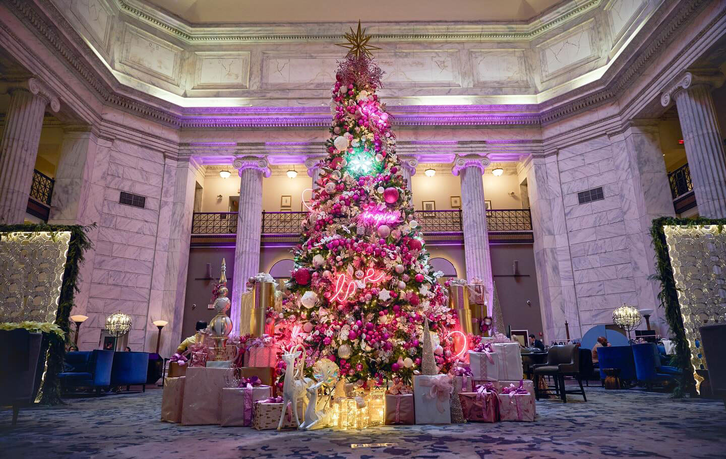 Christmas Tree decorated with lights ornaments and gifts in the Hotel Lobby