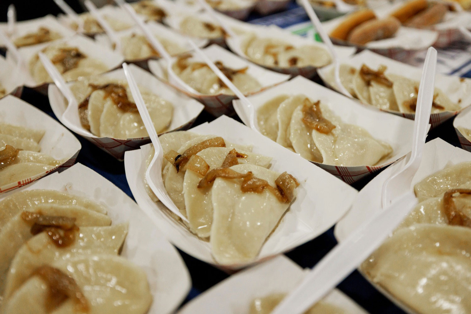 pierogies with fork served in boat plates