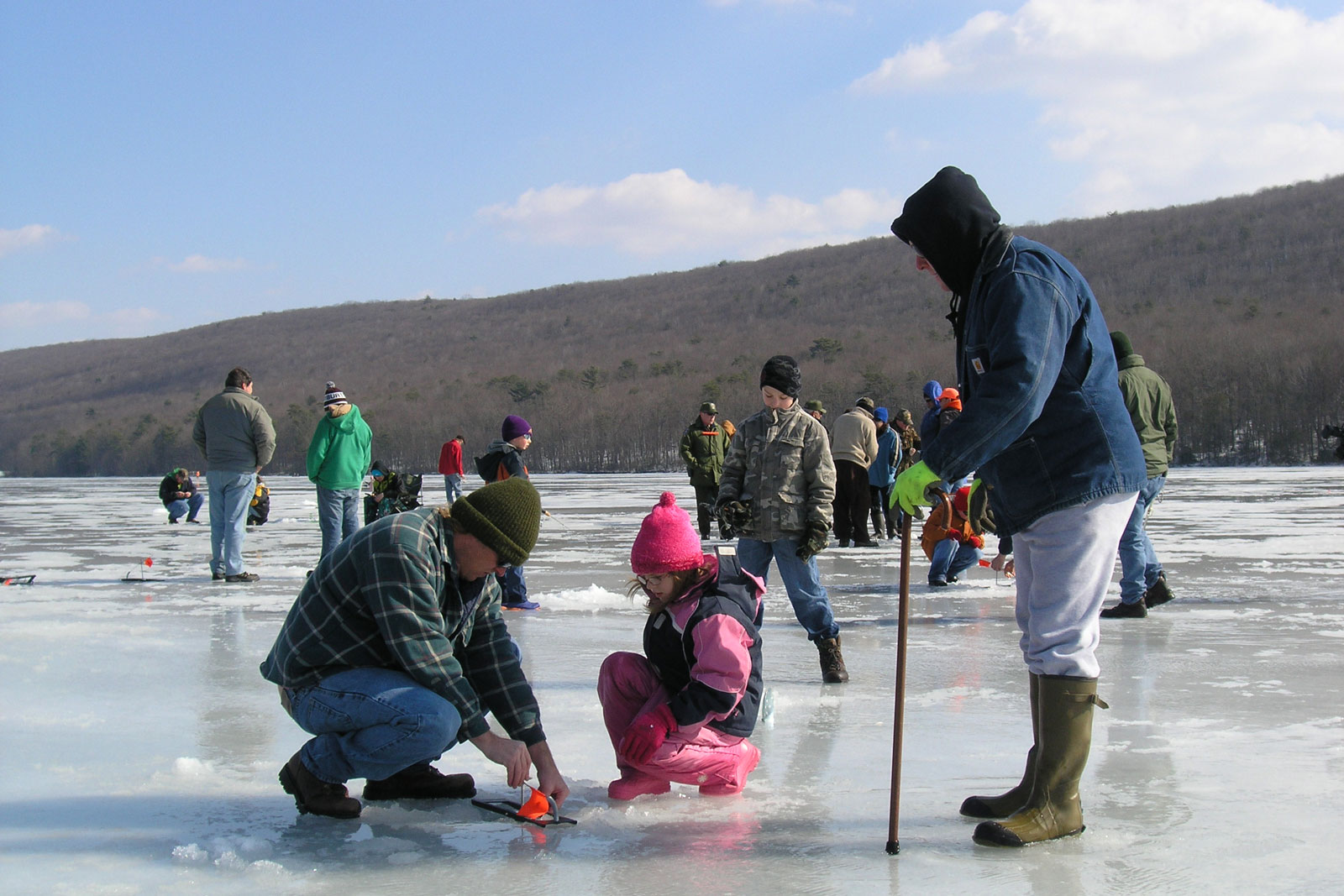 ice fishing on frozen lake