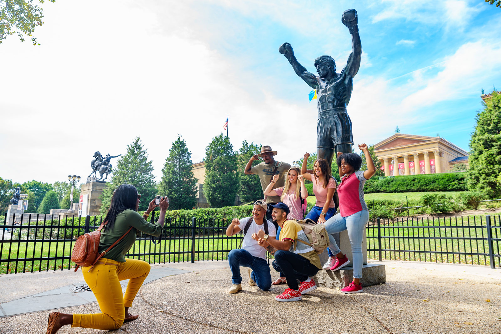 group of people posing for photo a Rocky Statue