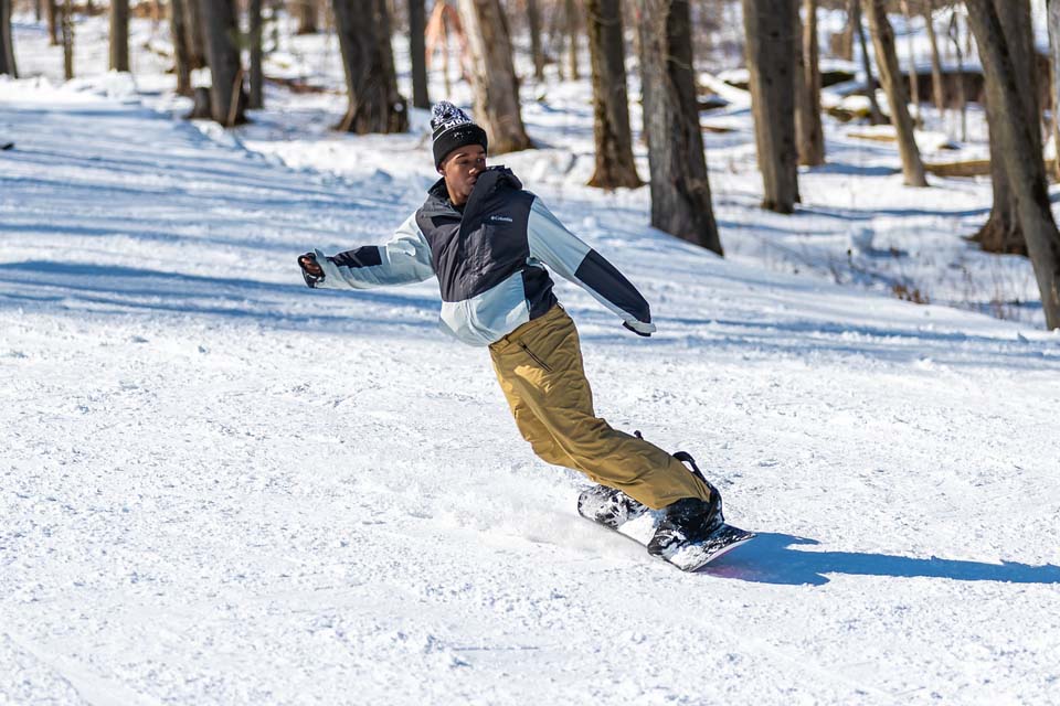 A person snowboarding down slope inclined