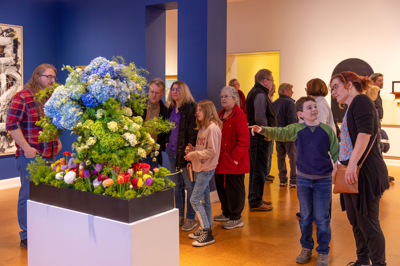 museum visitors looking at art bloom