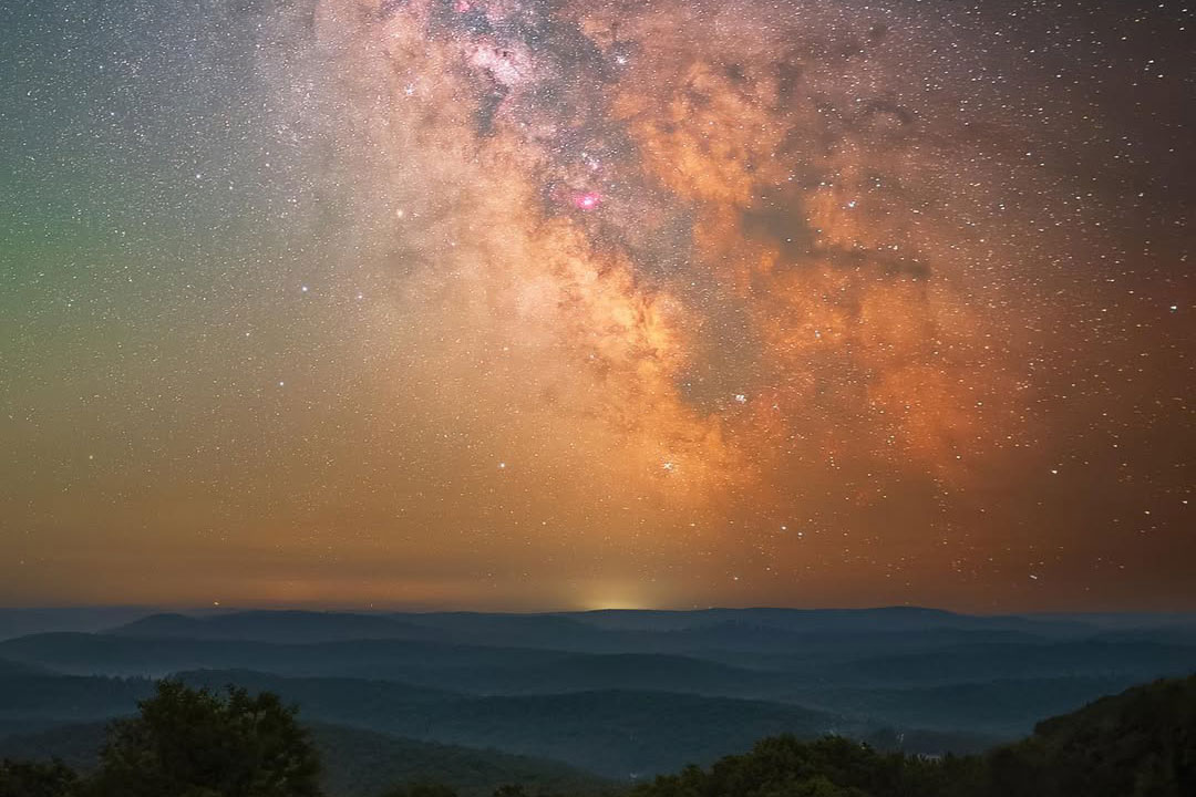 a large orange and yellow sky of twinkling stars