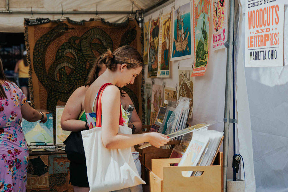 Two women looking at art works at Three Rivers Arts Festival