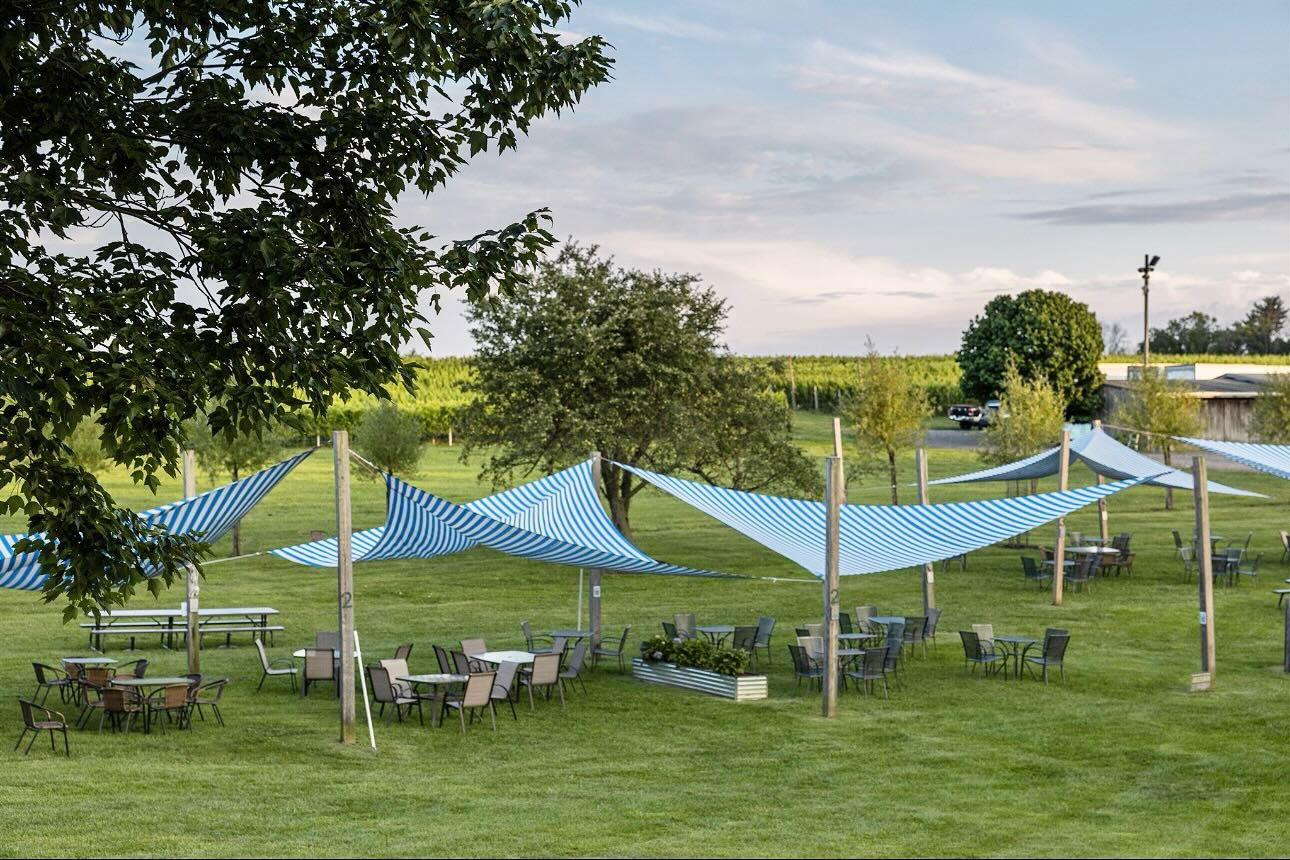 Tables and chairs with shade covers over at Penns Wood Winery