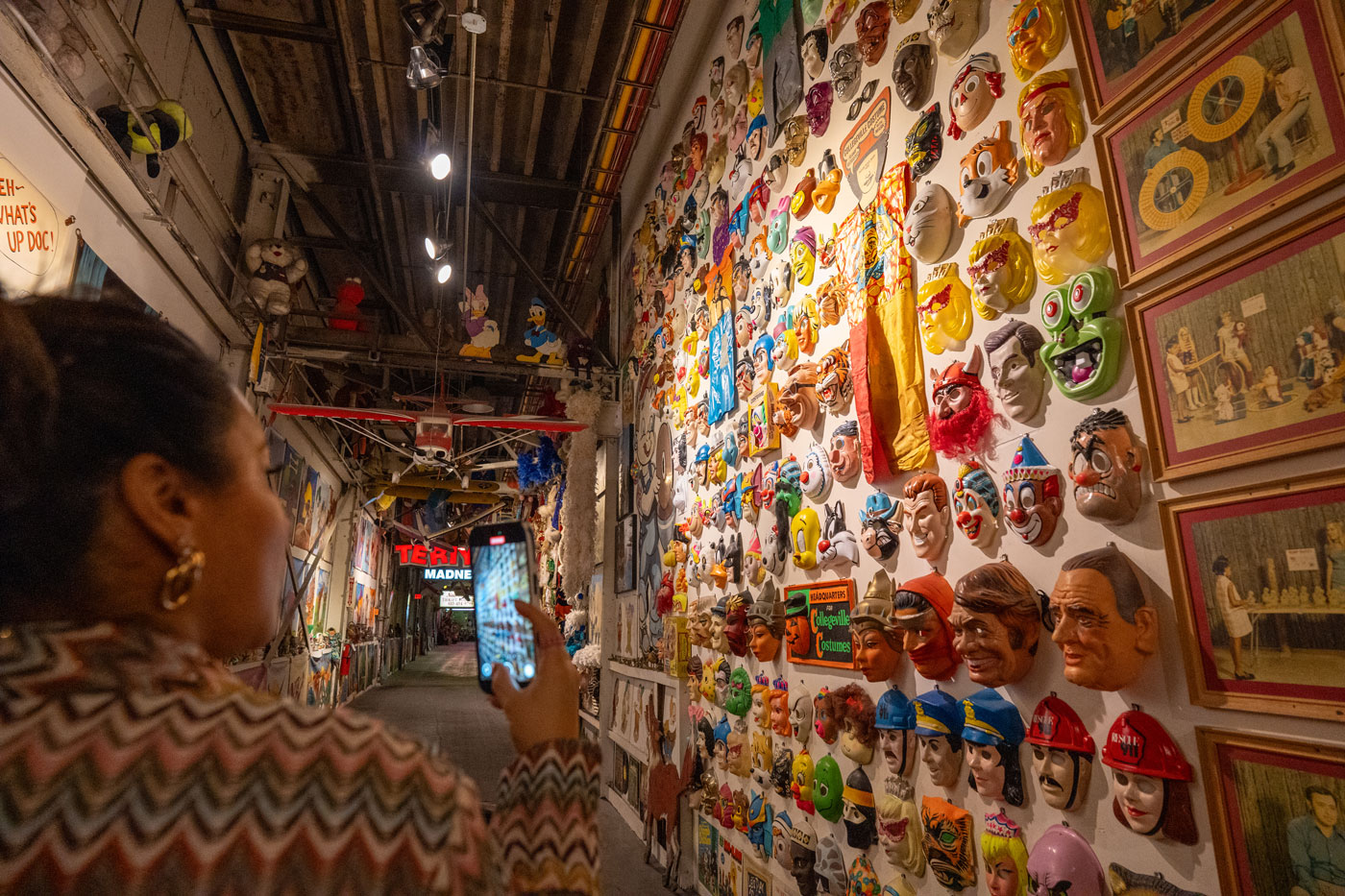 vintage characters mask wall at museum