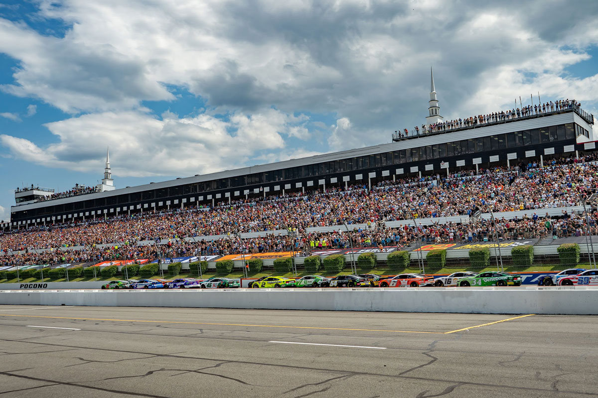 raceway grandstand view with Racecars racing at pocono raceway