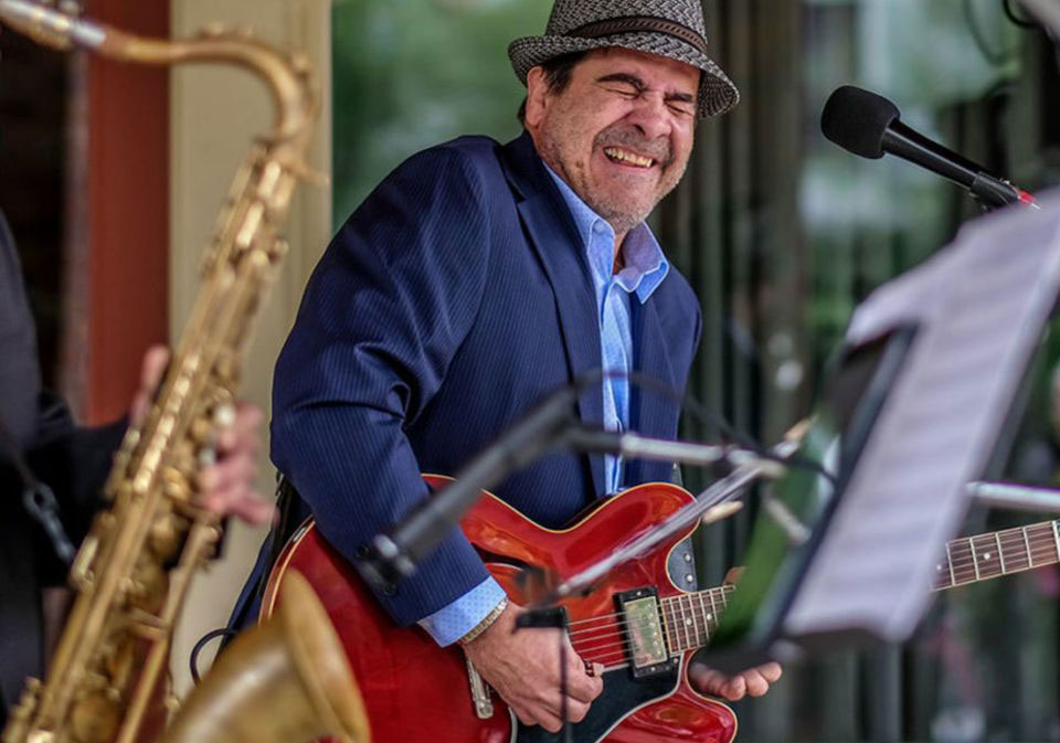 artist performing with guitar