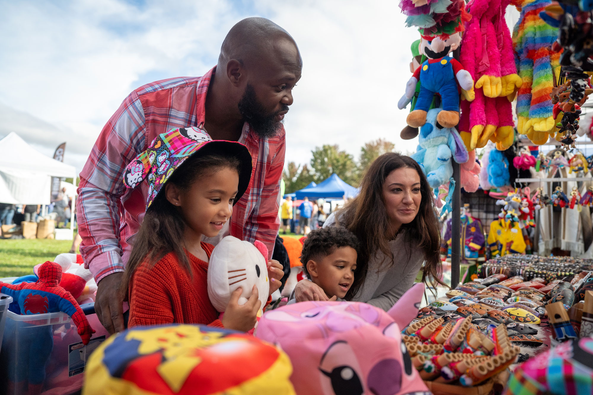 a family shopping at vendor stall